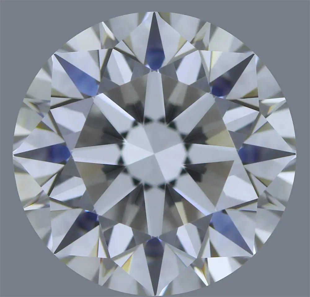 Close-up of a round, brilliant-cut diamond with a symmetrical pattern and multi-faceted surface on a gray background, perfect for enhancing your wedding services.