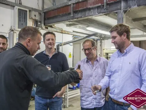 A group of men are standing in a wedding factory.