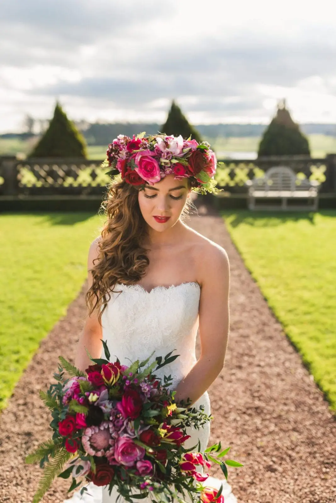 A bride wearing a floral crown in a garden during her wedding.