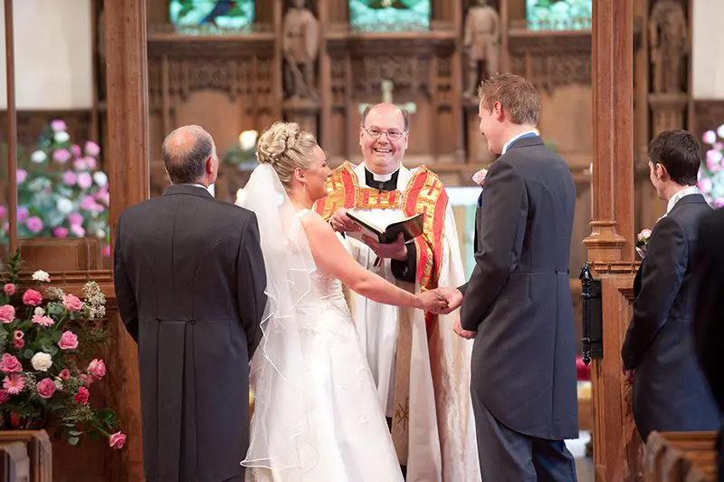 A bride and groom celebrate their wedding by exchanging their vows in a church, creating a beautiful moment that exemplifies the essence of the wedding ceremony.