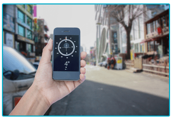 A person holding a smart phone in front of a busy city street, captured during wedding planning.