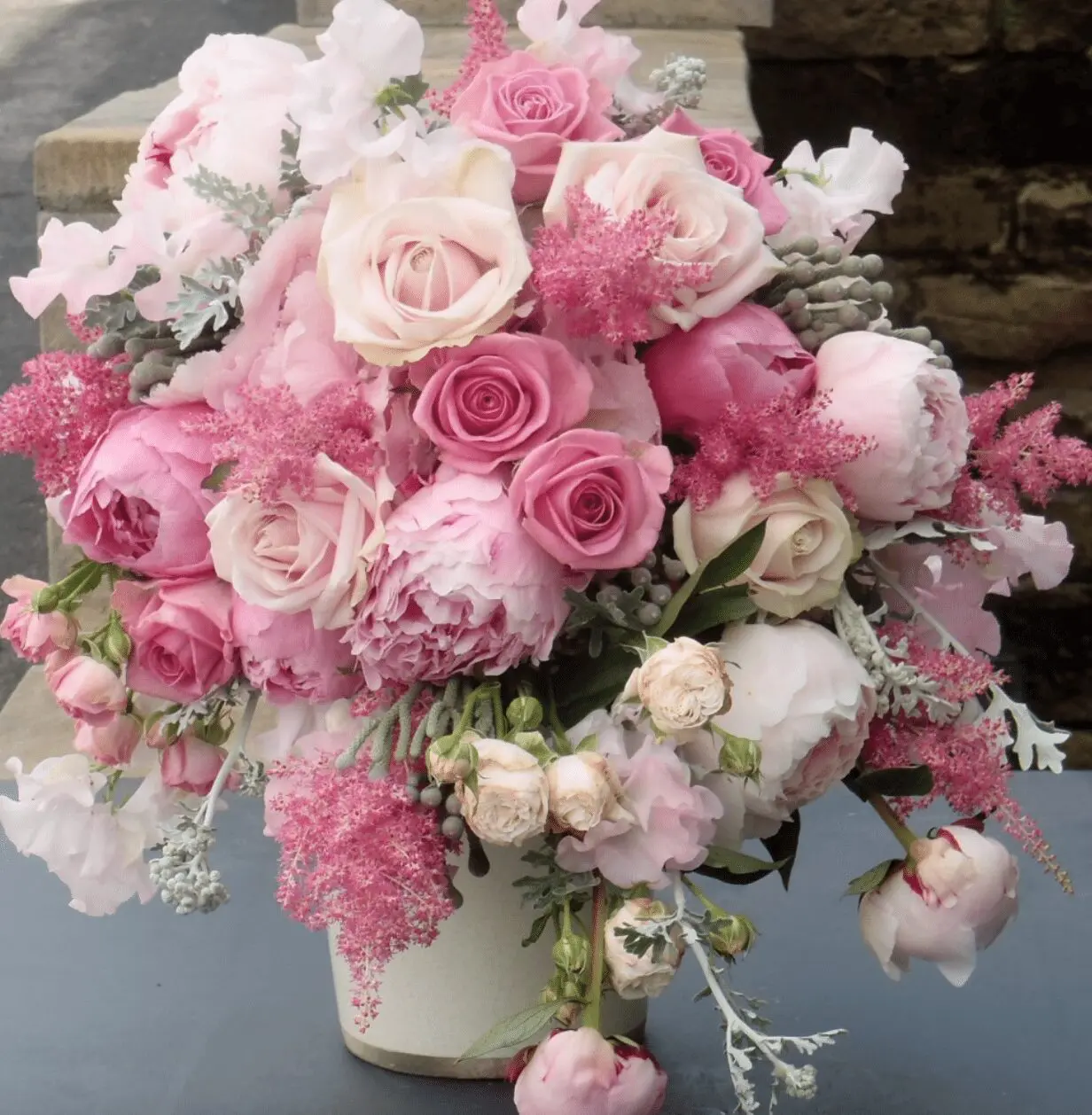 A wedding bouquet of pink and white flowers in a vase.