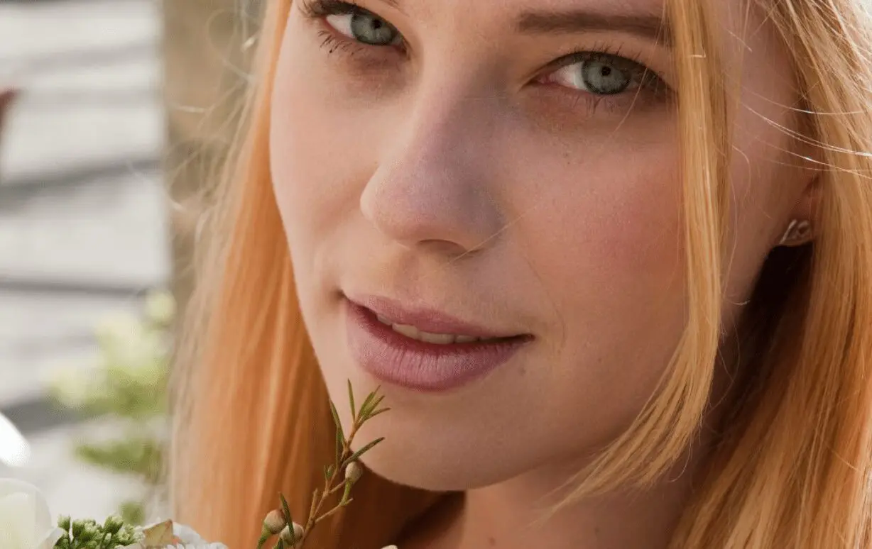 A young woman with a bouquet of flowers, beautifully representing wedding services.