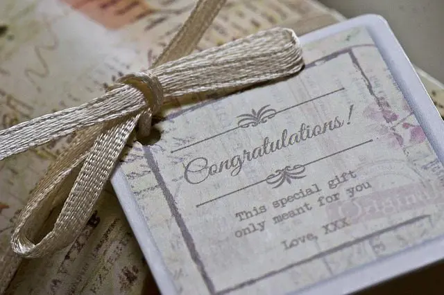 A elegant gift tag with a ribbon tied around it for wedding services.