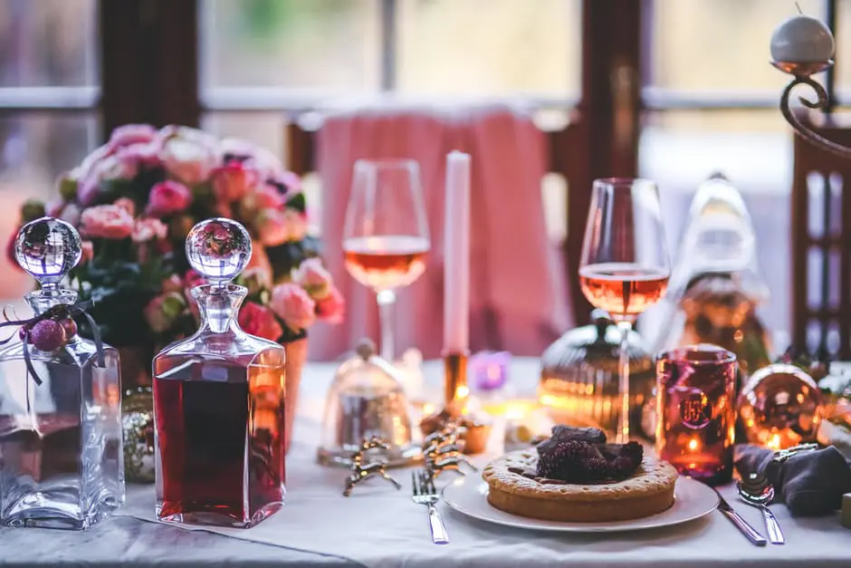 A beautifully arranged table for a dinner party with wine and desserts, perfect for wedding planning or other special events.