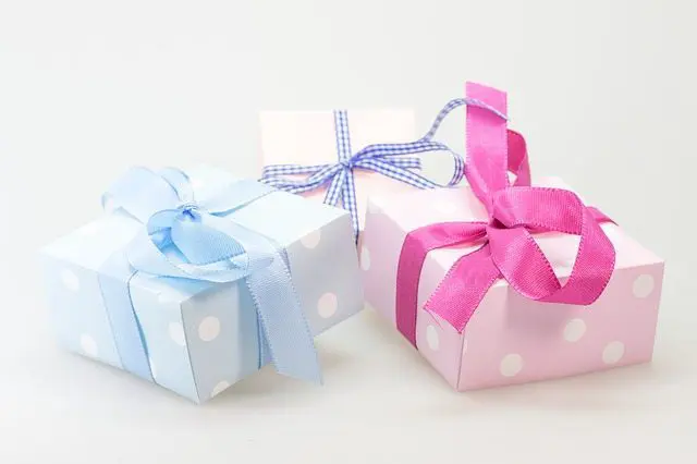 Three pink and blue gift boxes for wedding planning on a white background.
