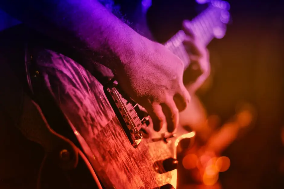 A person playing an electric guitar at a concert.
