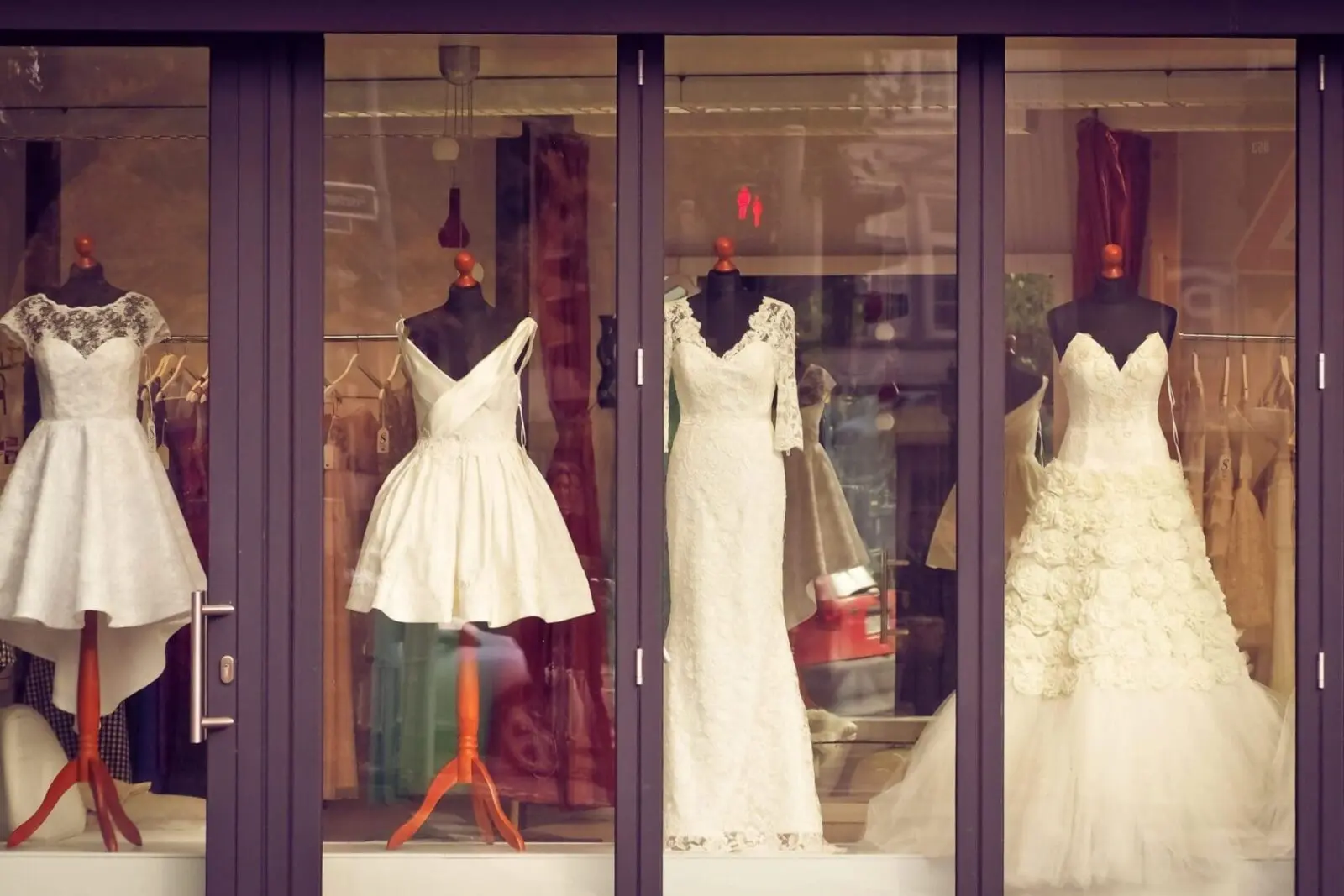 Wedding dresses on display in a shop window, showcasing the latest trends for brides planning their wedding day in the UK.