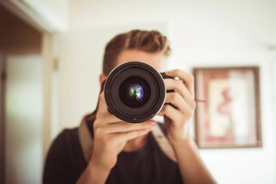 A man is taking a picture at a wedding.