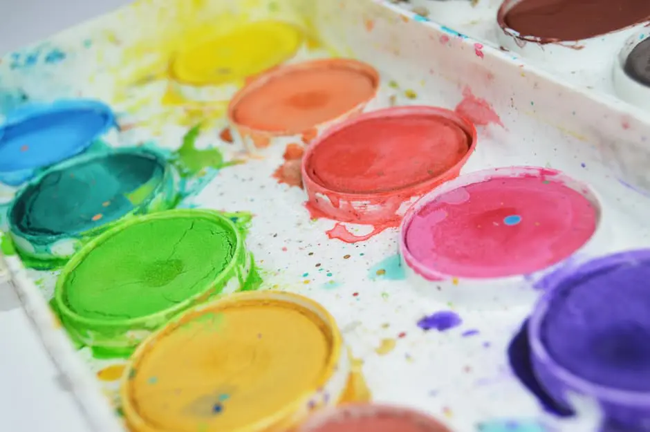 A set of watercolor paints on a white surface, perfect for Wedding Planning.