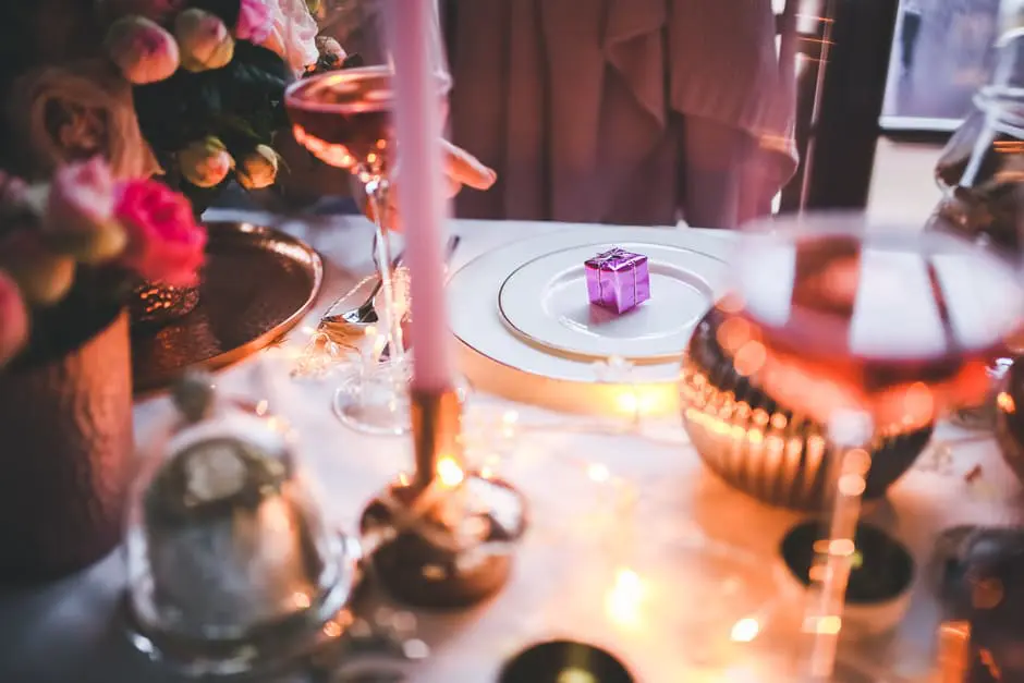 A romantic table setting featuring a glass of wine and a candle, perfect for wedding planning or showcasing at a wedding business in the UK.