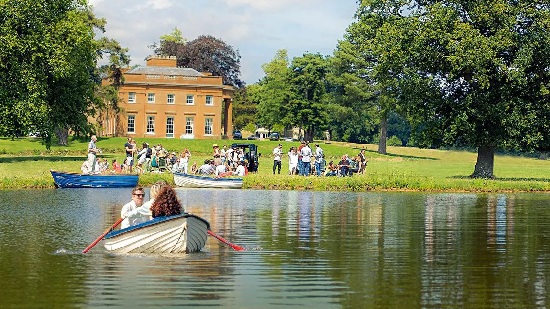 A group of people planning a wedding on a boat in a lake for their wedding business.