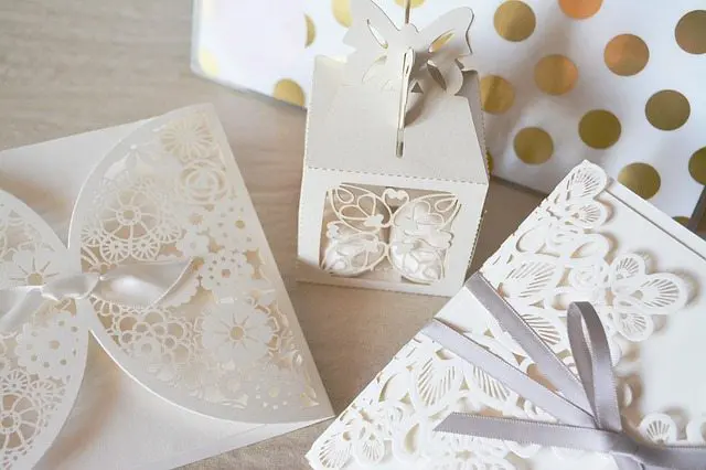 White butterfly wedding invitations with a polka dot pattern.