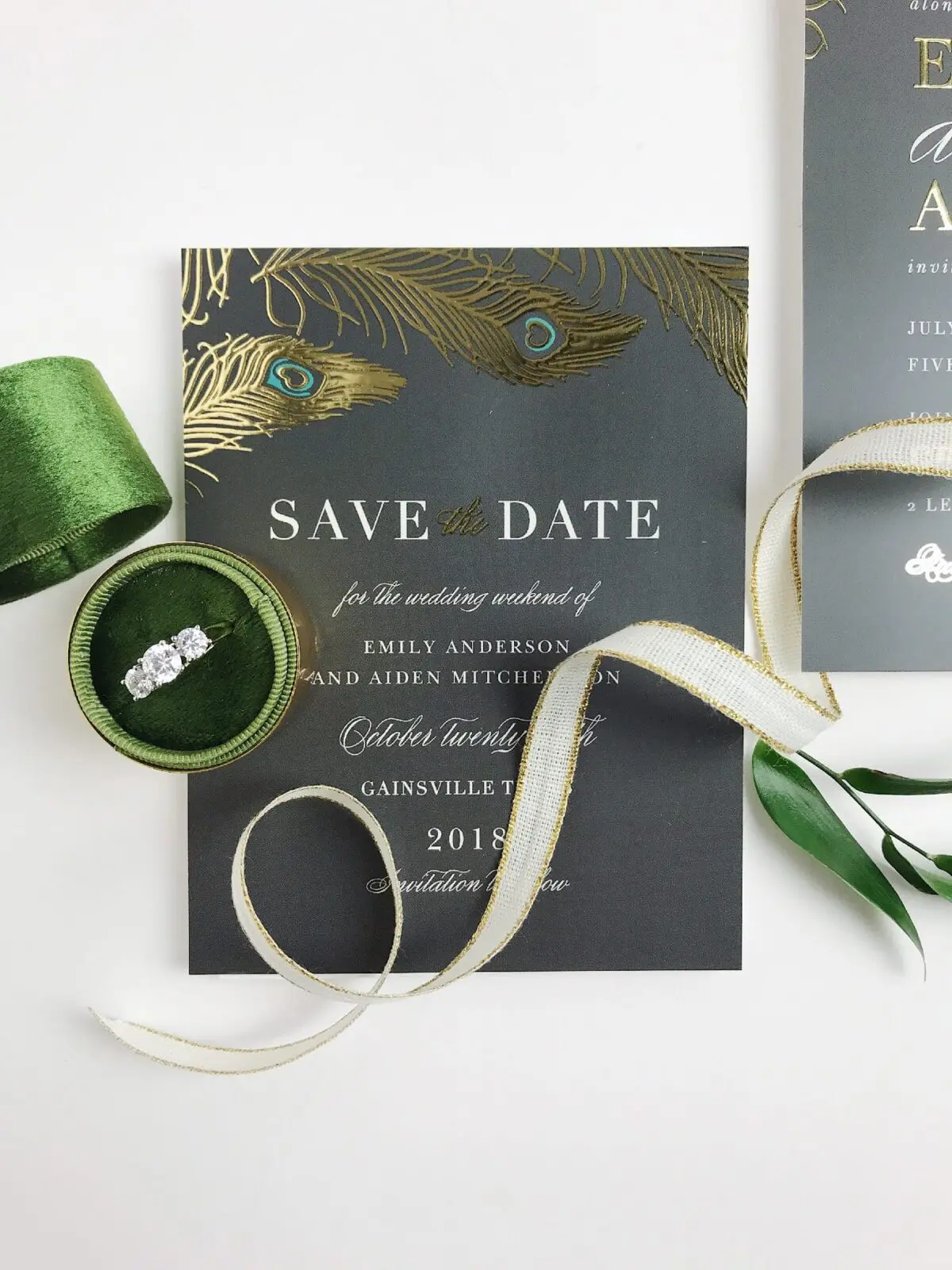 A "Save the Date" card for Emily and Aiden's wedding on October 29, 2018, in Gainesville. Perfectly tied with a ribbon and nestled in a green box with a ring, this elegant preview reflects meticulous wedding planning. A glimpse of another card hints at more delights to come.
