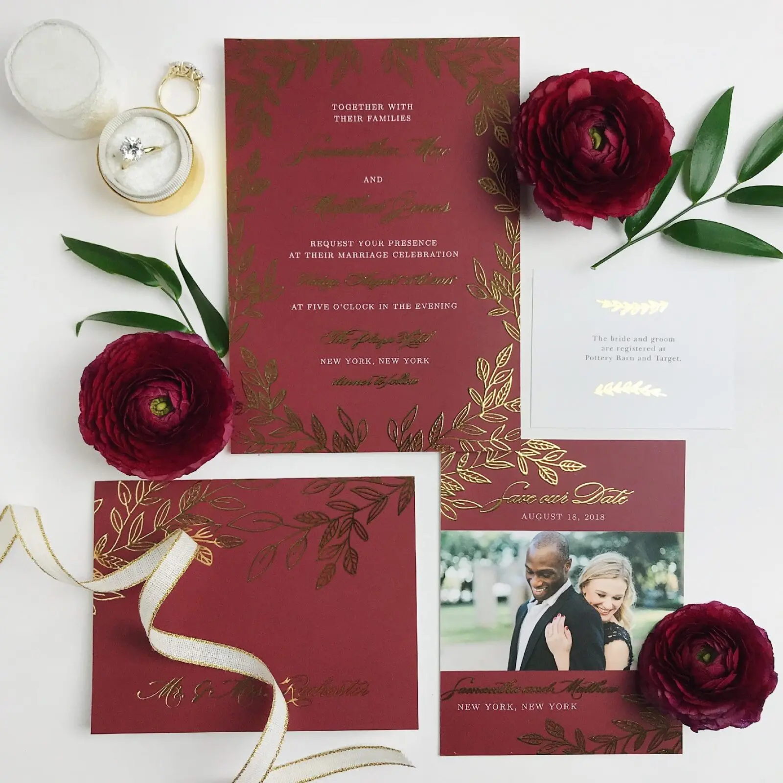 A beautifully crafted wedding invitation set featuring a red and gold design showcases your planning elegance. It includes a photo card, vibrant red flowers, a luxurious gold ribbon, and two rings on a delicate plate—perfect for celebrating your special day in style.