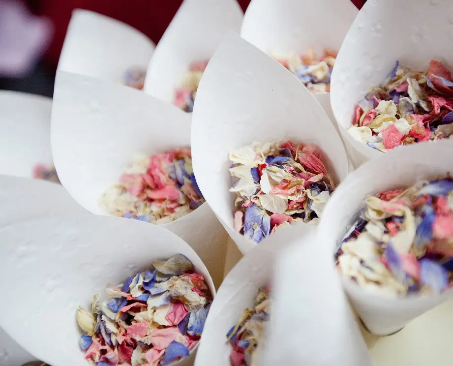 In wedding planning, vibrant cones of colorful dried petals are artfully arranged together.