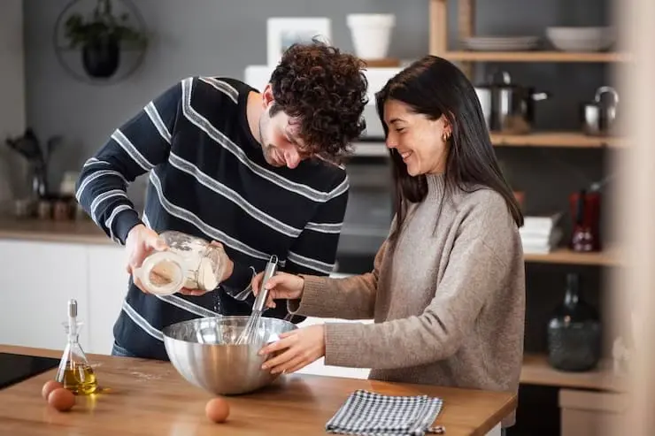 Newly wed couple enjoying cooking together