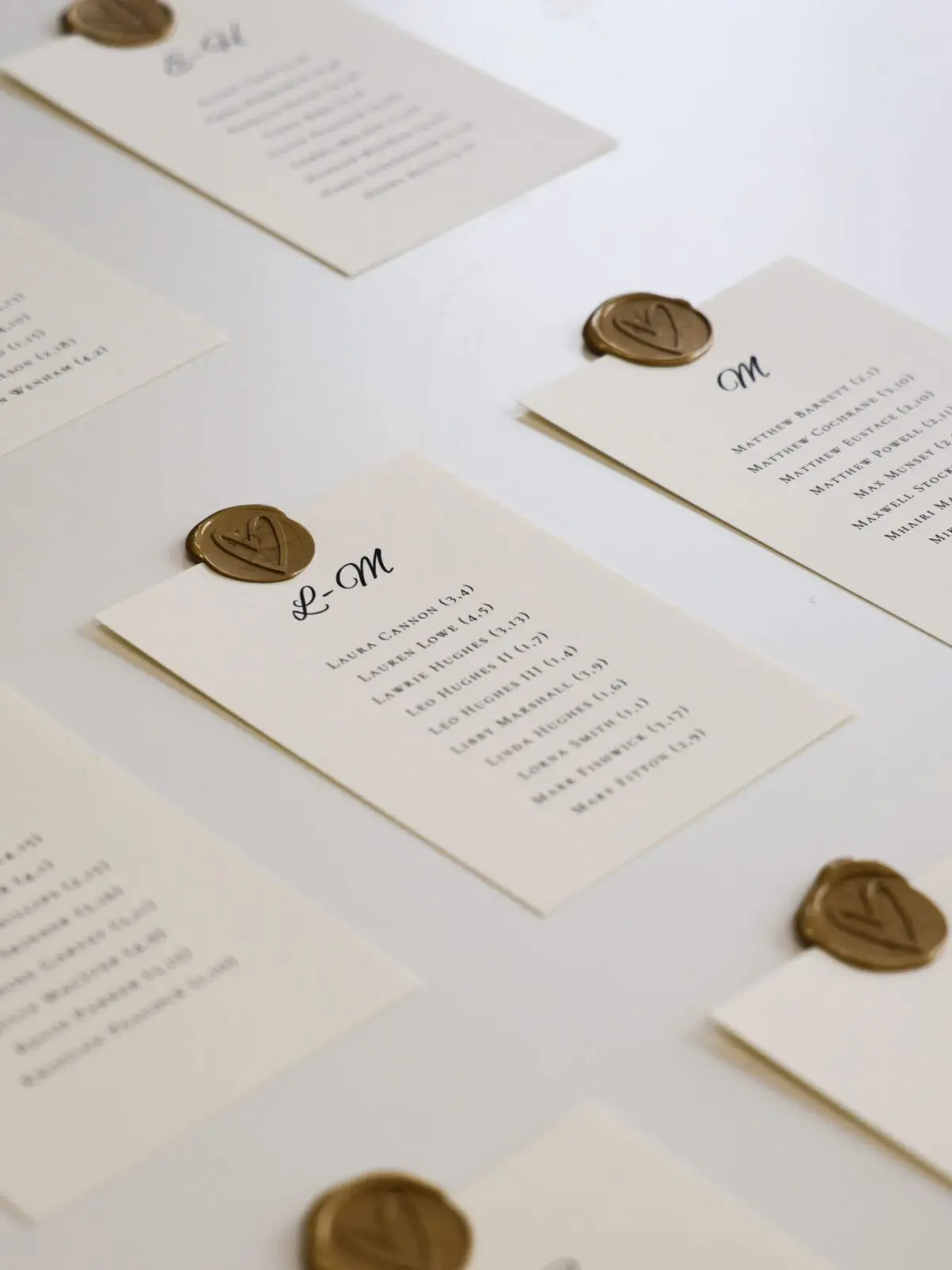White wedding seating plan cards laid out for wedding guests.
