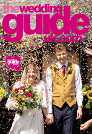 A bride and groom smile while colorful confetti falls around them, capturing a perfect moment in wedding planning bliss. The cover of "The Wedding Guide UK" magazine.