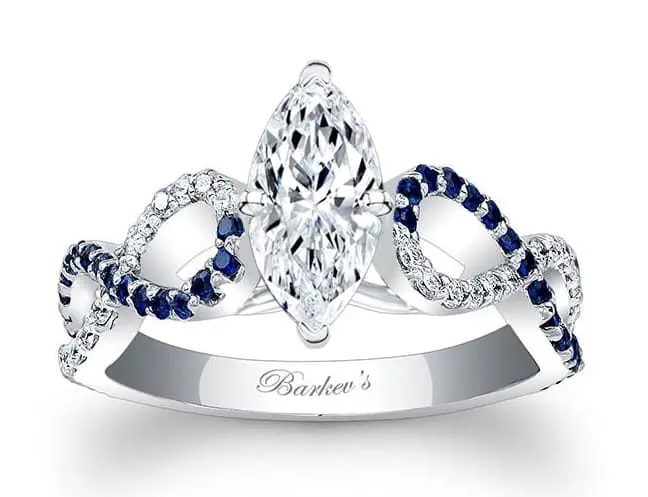 Marquise-cut diamond ring with an intricate band design featuring small blue and white stones, engraved with "Barkev's.