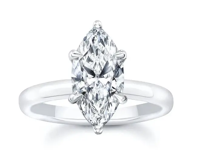 A marquise-cut diamond ring set in a silver band with four prongs.