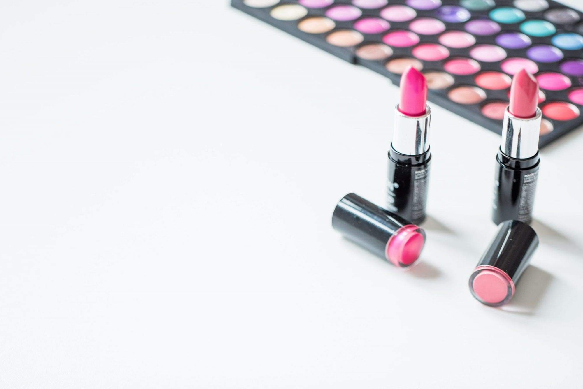 Wedding lipsticks and makeup palettes on a white background.