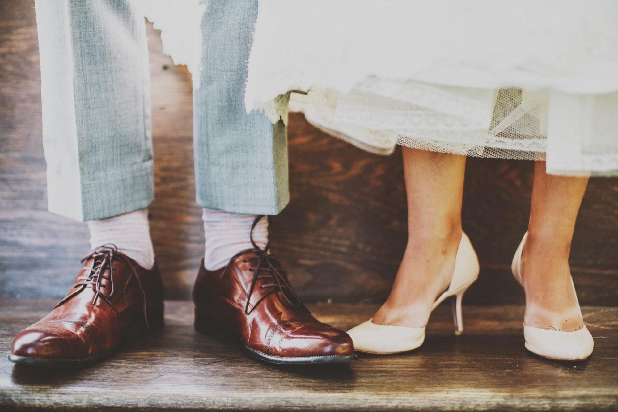 A wedding planning scenario in the UK, where the bride and groom's feet are standing next to each other.