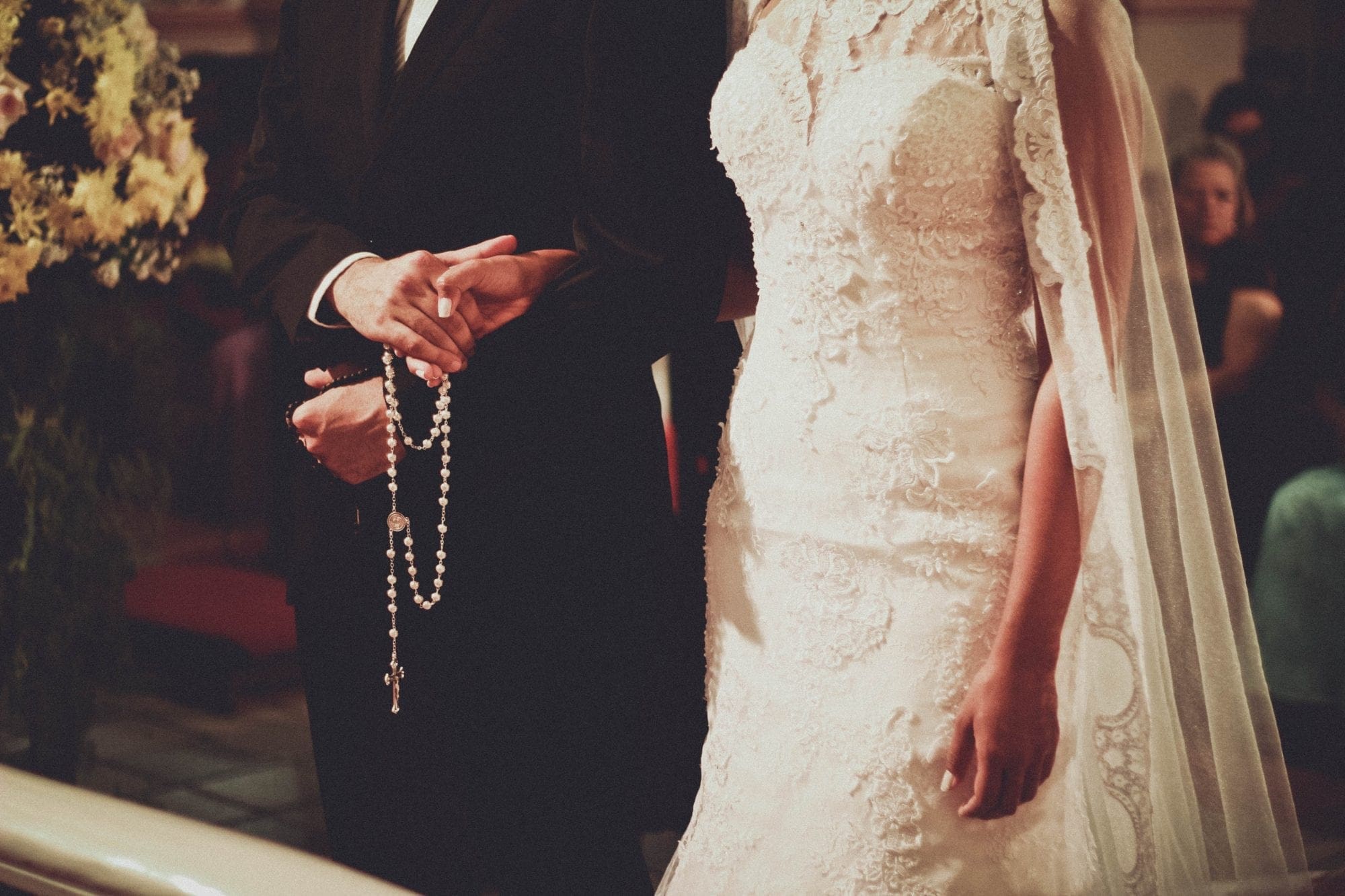 A bride and groom holding hands in a church.