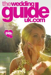 Cover of The Wedding Guide UK magazine featuring a woman in a white dress outdoors, with the sun setting in the background. The text includes "The planning starts here" and "wedding services at guideuk.com".